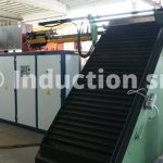 Induction heating plant for metals hot forging with rolling shutter loader
